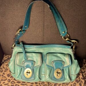 Coach turquoise leather handbag. Two turn lock front pockets and a zip pocket